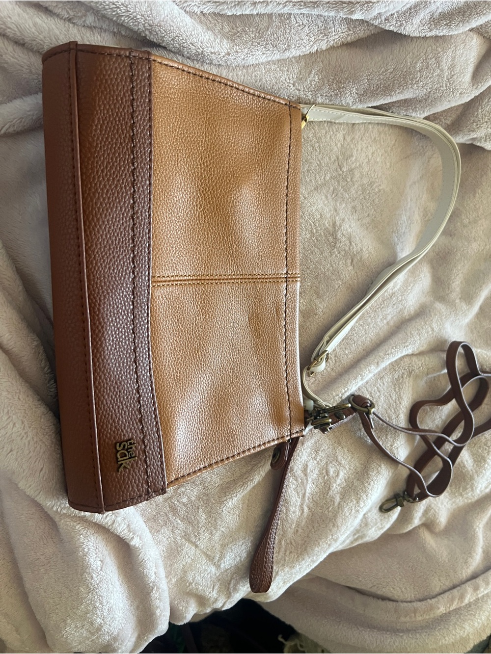 The Sak white and tan Leather crossbody bag with teal interior.